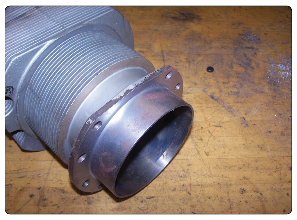 The aluminum head and steel barrel of a cylinder.