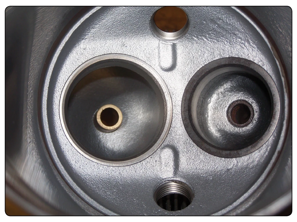 View of valve guide installed on a cylinder head.