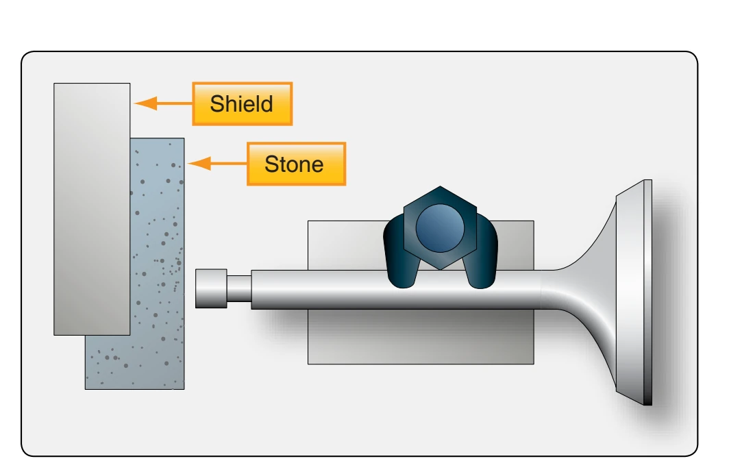 Grinding a valve tip.