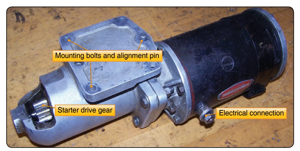 Starter drive gear mounting holes and electrical connector.