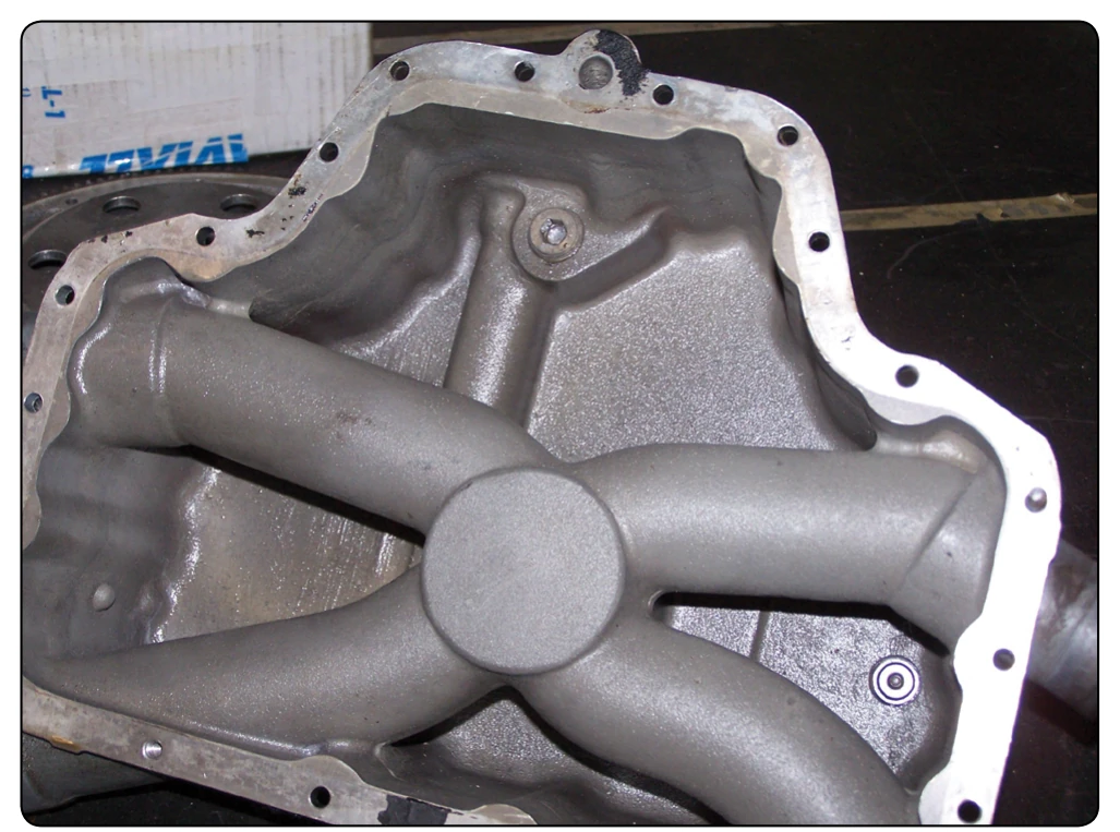 Wet-sump system’s sump with intake tube running through it.