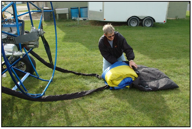 Figure 5-23. With the wing folded, you pull it into the bag.