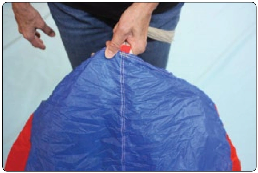 Figure 4-13. Pull the tail up over the canopy and hold it under your thumb.