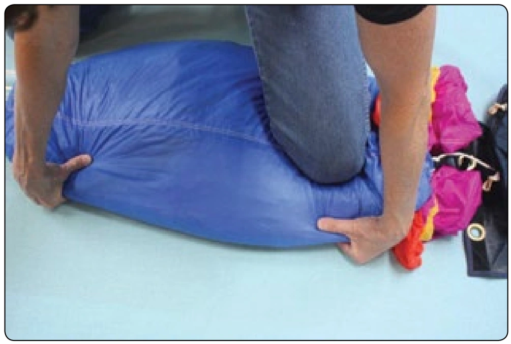 Figure 4-20. Use a knee to keep control of the top of the canopy.
