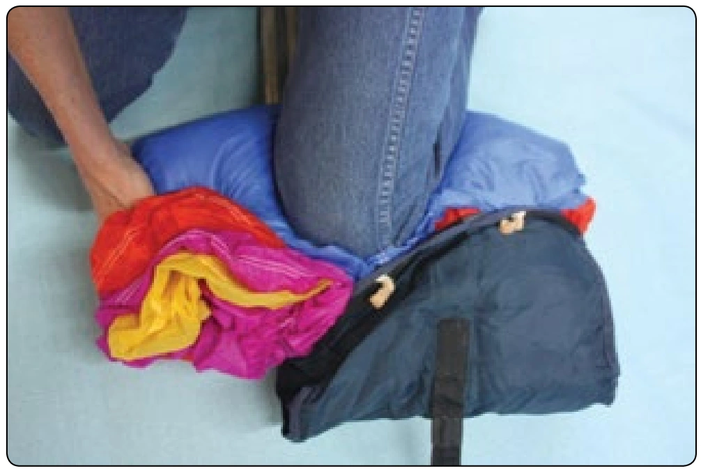 Figure 4-25. Insert the canopy into the bag one side at a time.