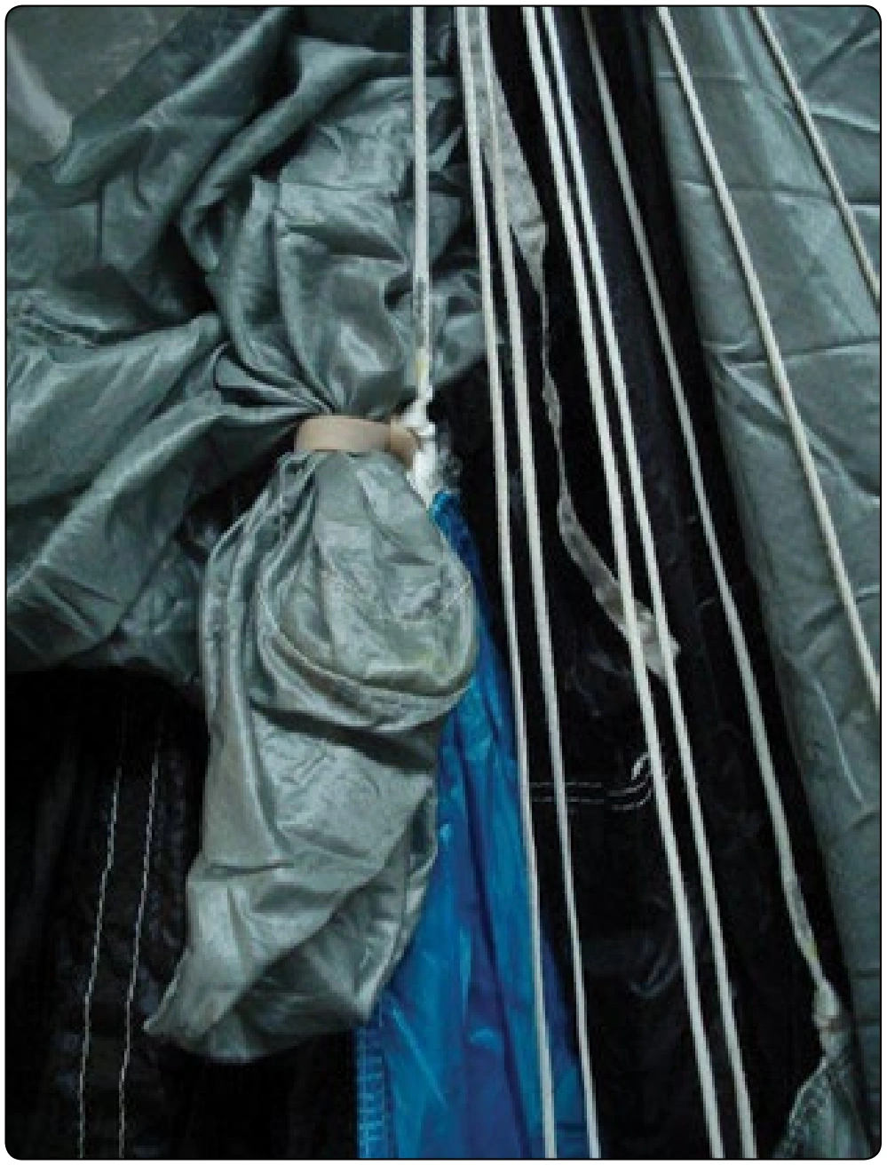 Figure 4-37. Rubber band on center C-Line attachment tab holding apex of slider.