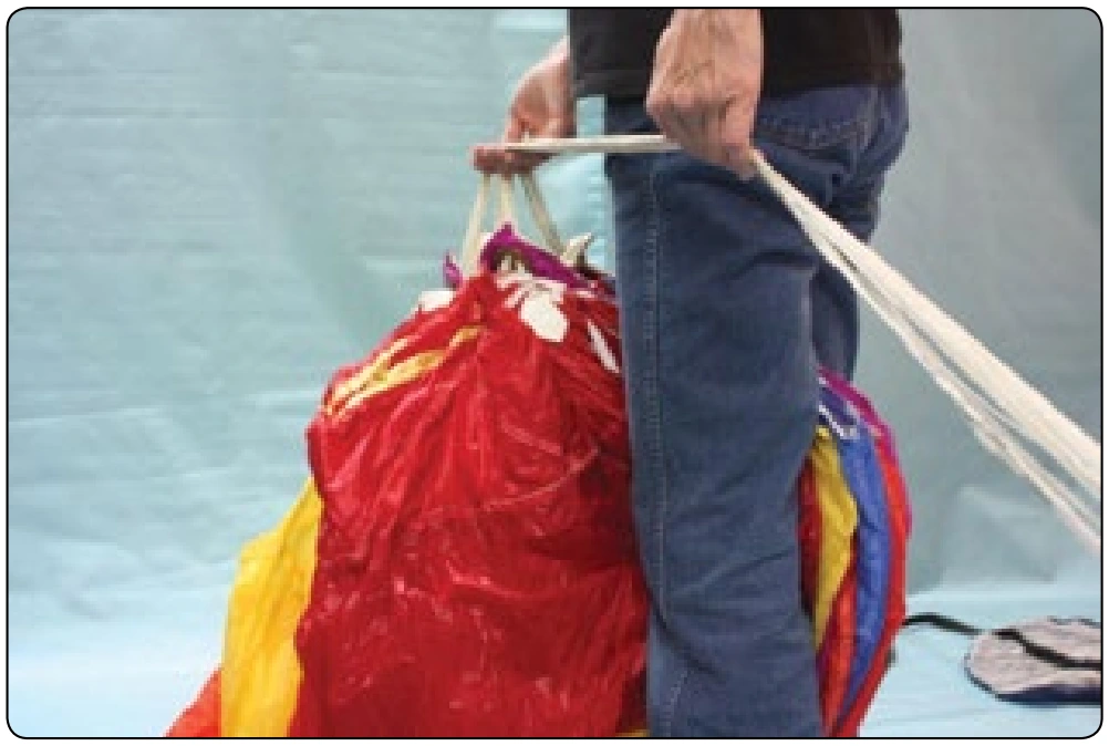 Figure 4-8. Tuck the nose of the canopy between your legs.