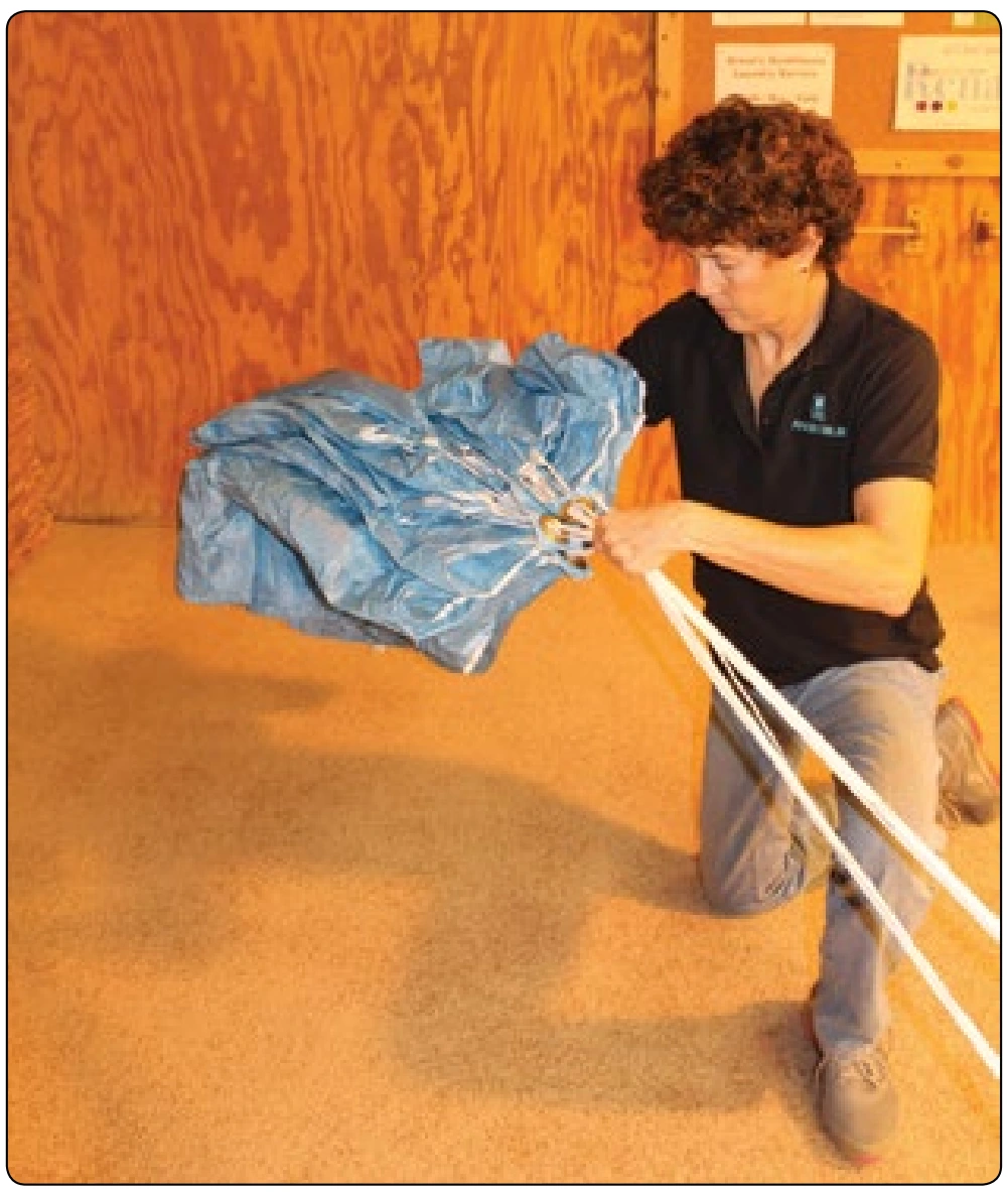 Figure 5-121. Sweep arm underneath flaked canopy and gently lay it on the floor.