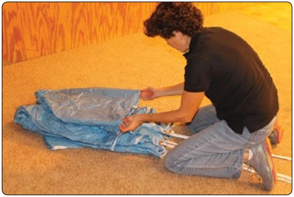 Figure 5-128. Without disturbing the rest of the folds, pull the center tail section down to the slider grommets.
