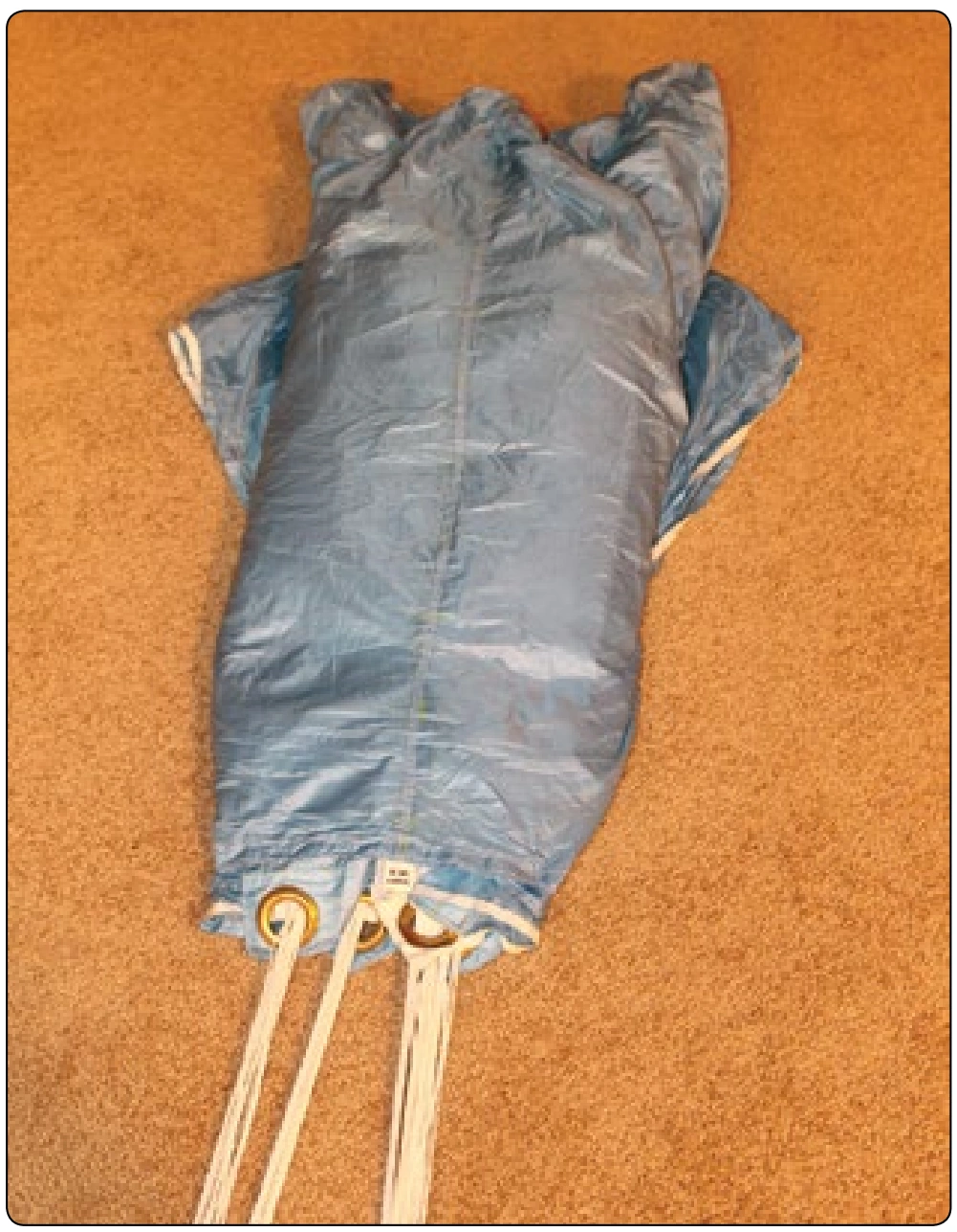 Figure 5-129. Cocoon the canopy by wrapping the tail around and under. The nose is splayed out with three cells to the right, three cells to the left, and the center cell in the middle.