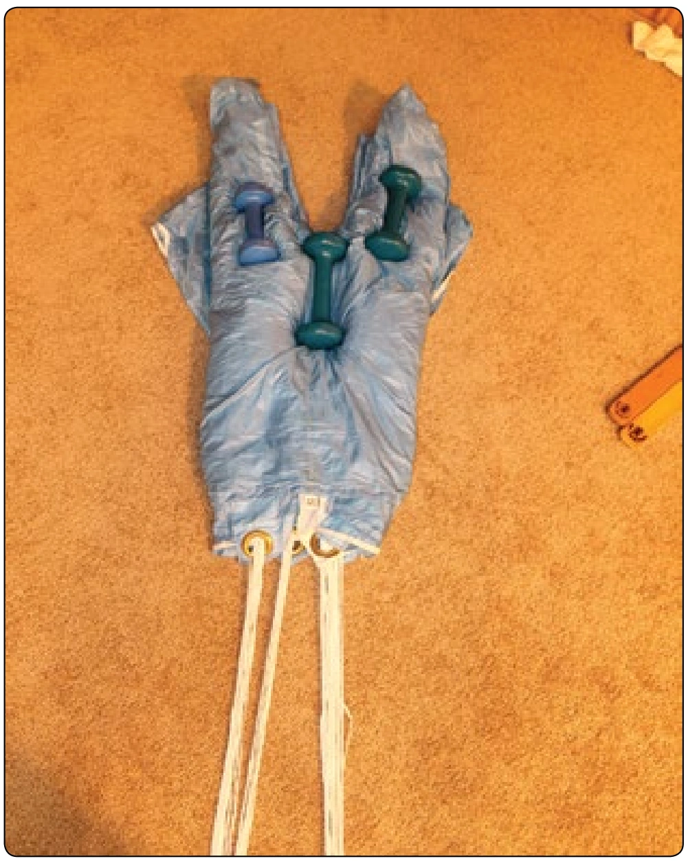 Figure 5-130. Accordion the center cell, dividing the canopy in half. Weights can be used to control the pack job.