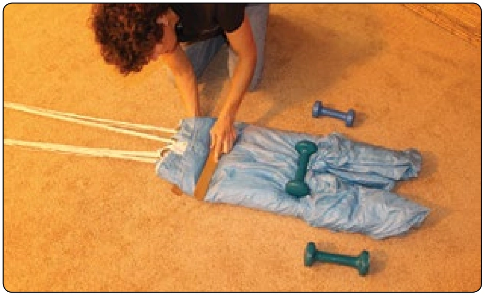 Figure 5-131. Two packing paddles can be used to make a neat S-fold.