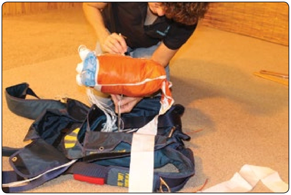 Figure 5-145. A bodkin that has been pre-loaded through the backpad of the container can now be easily pulled through the bag using this second bodkin.