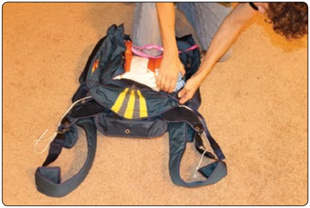 Figure 5-147. Carefully tuck the corners of the bag into the bottom of the container.