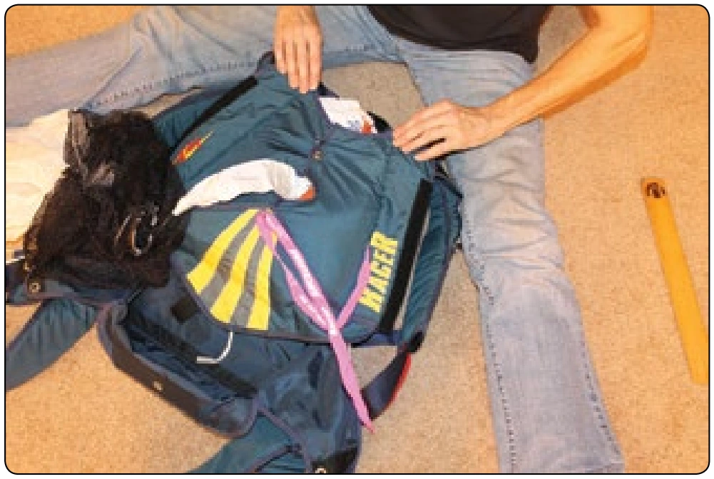 Figure 5-154. Close other side flap leaving a short section of bridle below the pilot chute.