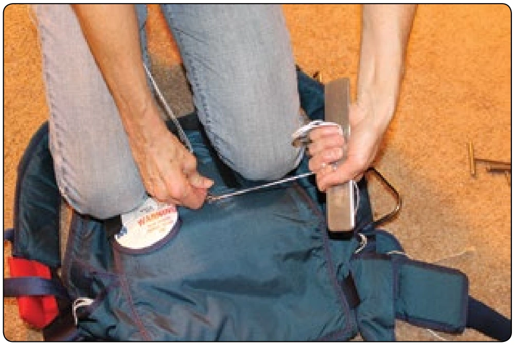 Figure 5-162. Pull bottom closing loop through the grommet and insert pin.