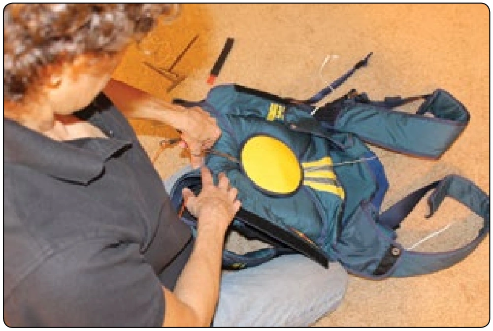 Figure 5-164. Insert running ends into the isolated space between pilot chute “Hat” and top of the spring, using a hemostat or tweezers.