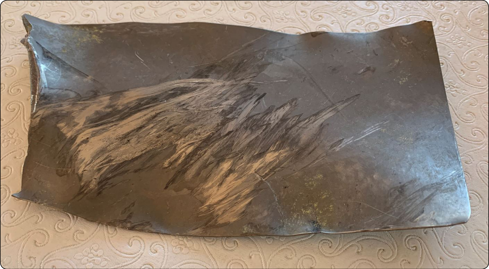 Figure 8-3. Sheared off titanium fan blade with feather impressions.